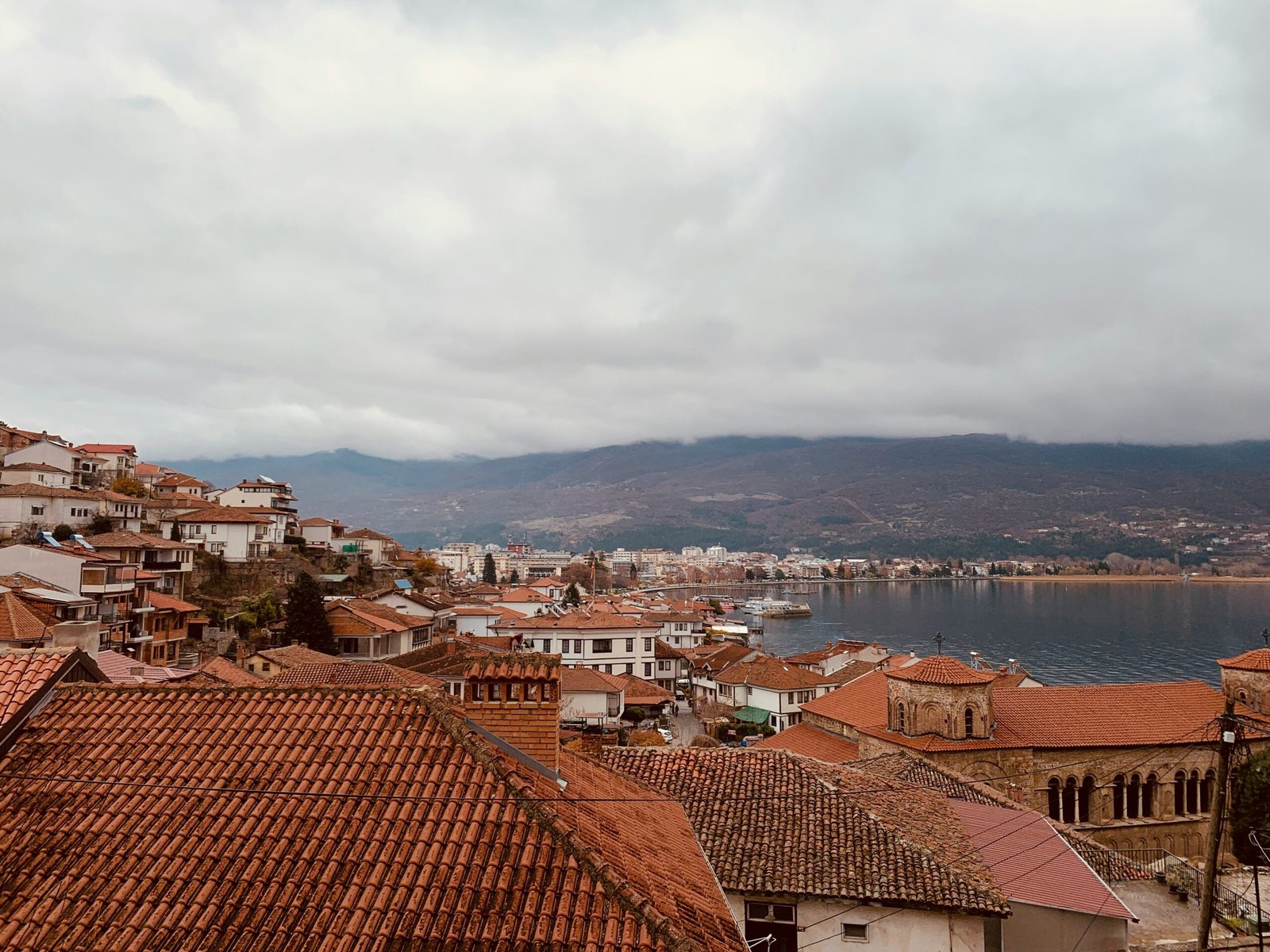 brown and white concrete houses near body of water during daytime