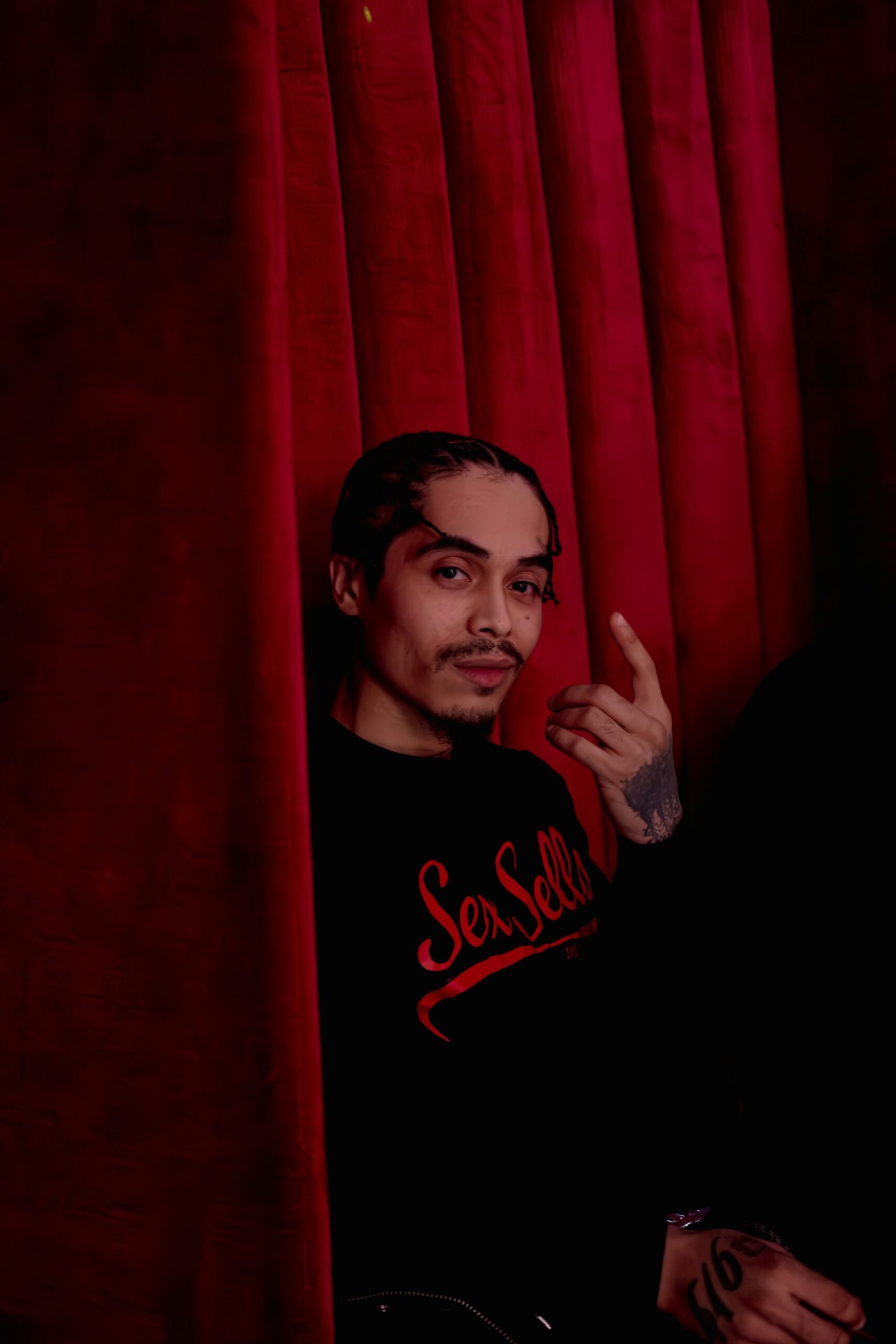 a man standing in front of a red curtain