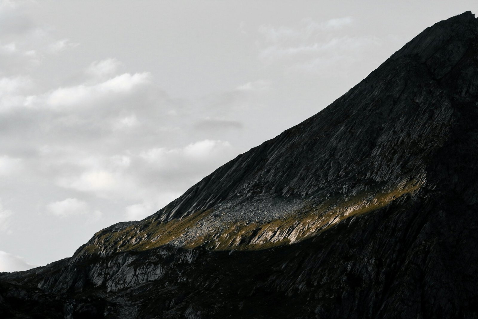 black and white mountain under white clouds